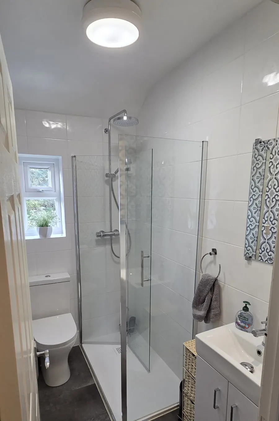 Very small bathroom with a made-to-measure shower tray, glass enclosure, toilet and vanity basin